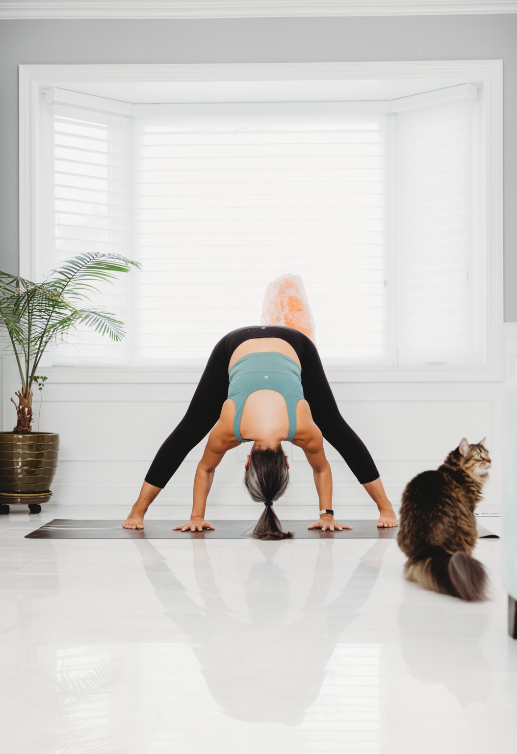 Sandy stretching at home beside her cat